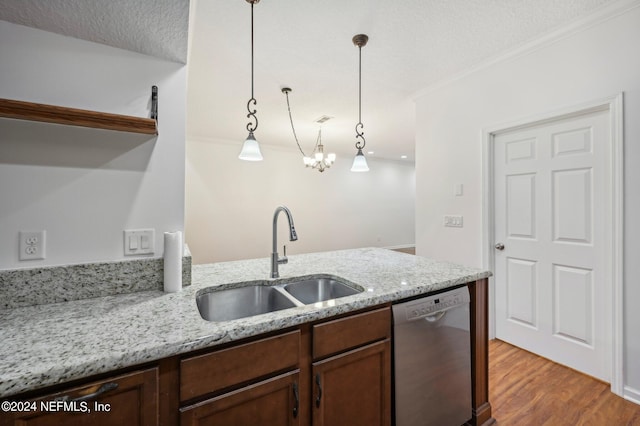 kitchen with light stone countertops, hanging light fixtures, sink, dishwasher, and light wood-type flooring