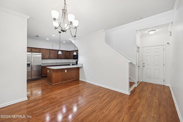 kitchen with stainless steel refrigerator with ice dispenser, decorative light fixtures, dark hardwood / wood-style floors, and sink