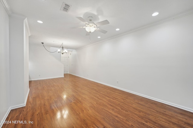 spare room with ornamental molding, wood-type flooring, and ceiling fan with notable chandelier