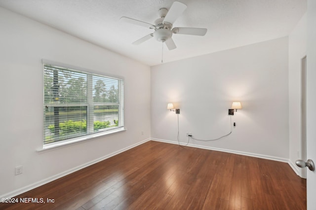 spare room with ceiling fan and dark hardwood / wood-style floors