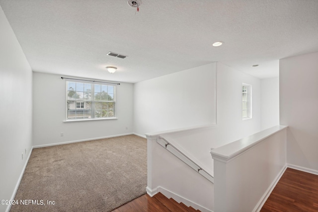 interior space with wood-type flooring and a textured ceiling