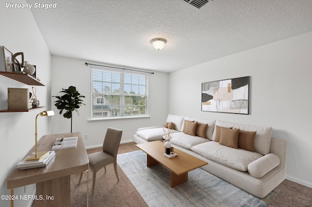 living room with carpet floors and a textured ceiling