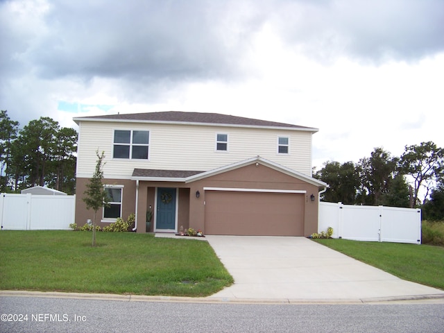 view of property with a garage and a front lawn