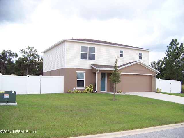 front of property featuring a garage and a front lawn