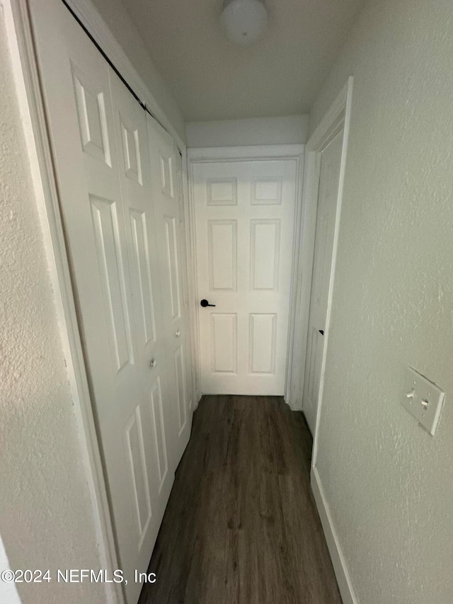 hallway with dark hardwood / wood-style floors