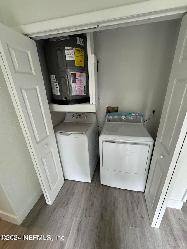 laundry room featuring hardwood / wood-style floors and washer and dryer