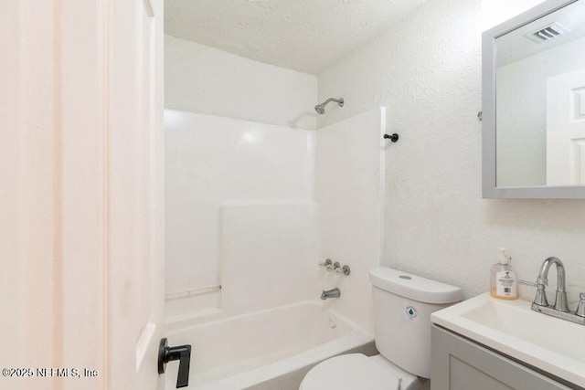 full bathroom with vanity, shower / bathtub combination, toilet, and a textured ceiling