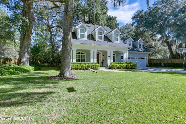 cape cod house with covered porch and a front yard