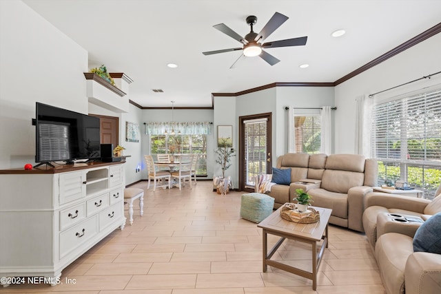 living room with ceiling fan, crown molding, and light hardwood / wood-style floors