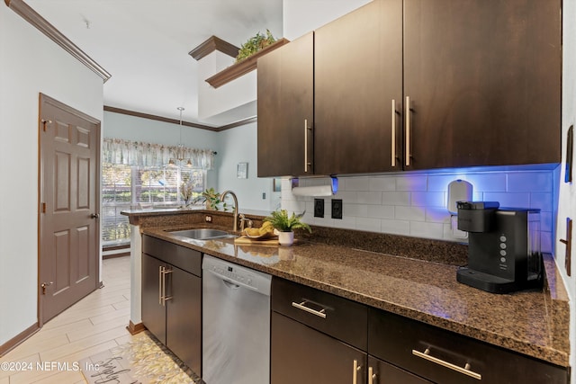 kitchen featuring stainless steel dishwasher, dark stone counters, crown molding, sink, and decorative light fixtures