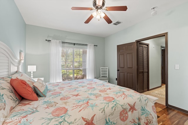 bedroom with ceiling fan, light wood-type flooring, and a closet