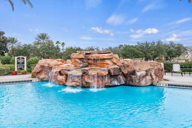 view of pool featuring pool water feature