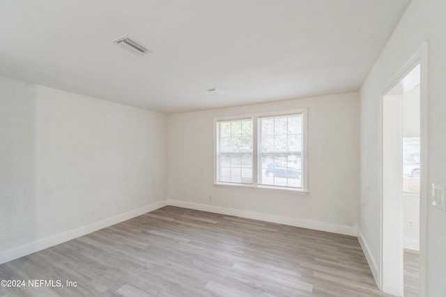 spare room with light hardwood / wood-style flooring