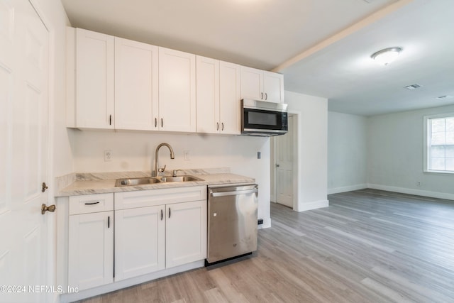 kitchen with white cabinets, sink, light wood-type flooring, and stainless steel appliances