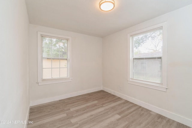 unfurnished room with light wood-type flooring