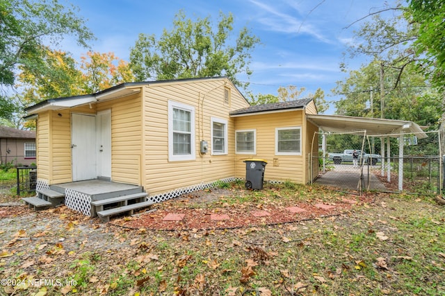 back of property featuring a carport