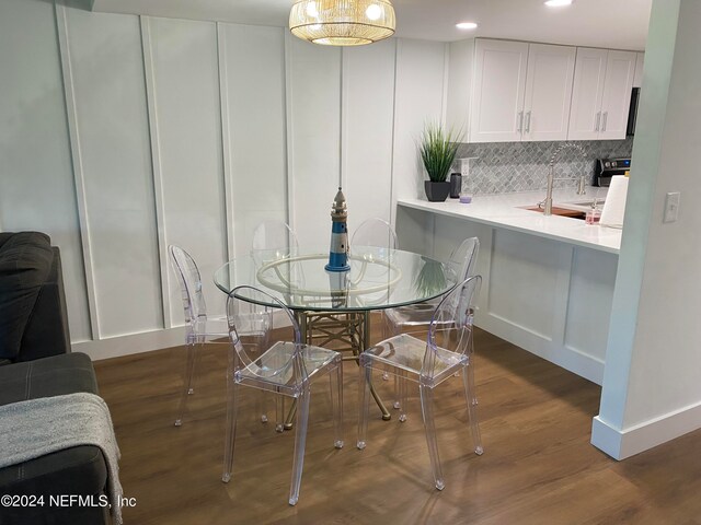 dining space featuring dark wood-type flooring