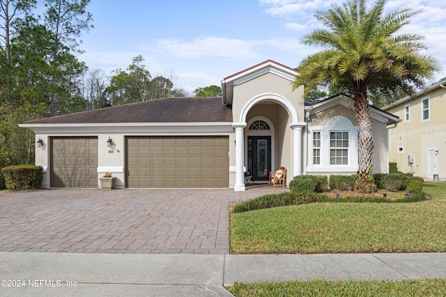 view of front of house featuring a front yard and a garage