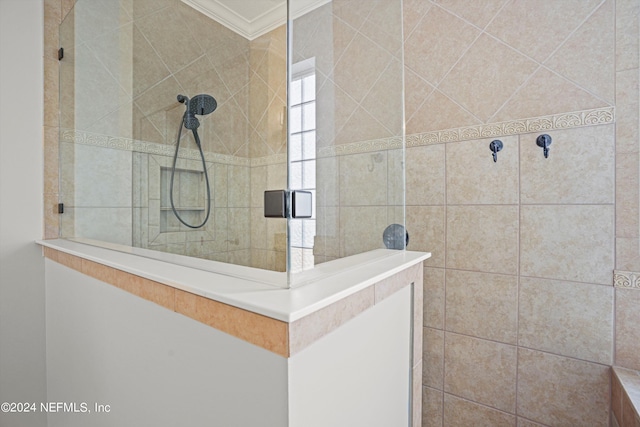 bathroom with crown molding and tiled shower