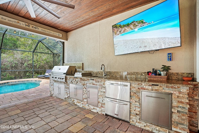 view of patio featuring ceiling fan, sink, grilling area, area for grilling, and a lanai