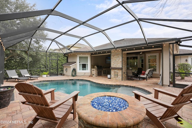 view of pool with area for grilling, glass enclosure, ceiling fan, and a patio area