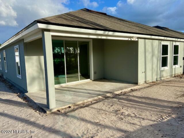 view of side of home with a patio area