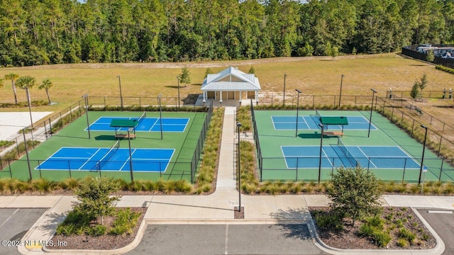 view of sport court featuring a lawn