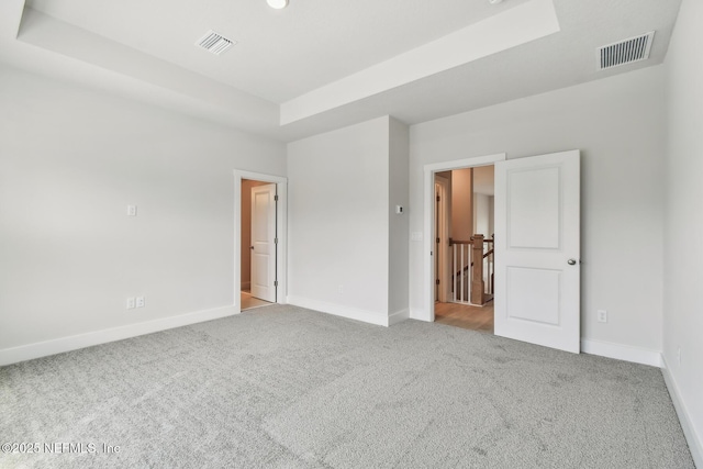 10266 Element Rd, Jacksonville, FL 32256 - empty room with a tray ceiling, carpet, and baseboards