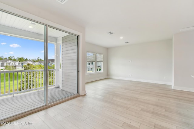 10266 Element Rd, Jacksonville, FL 32256 - spare room featuring light wood-type flooring, baseboards, and a residential view