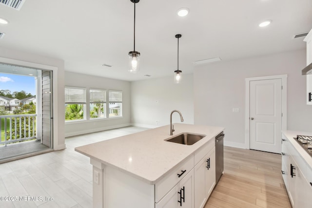 10266 Element Rd, Jacksonville, FL 32256 - kitchen featuring a sink, appliances with stainless steel finishes, decorative light fixtures, light wood-type flooring, and white cabinets
