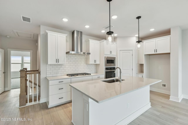10266 Element Rd, Jacksonville, FL 32256 - kitchen featuring wall chimney exhaust hood, a sink, stainless steel appliances, white cabinets, and recessed lighting