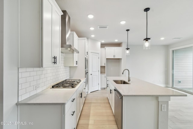 10266 Element Rd, Jacksonville, FL 32256 - kitchen with wall chimney exhaust hood, stainless steel appliances, a sink, backsplash, and a center island with sink
