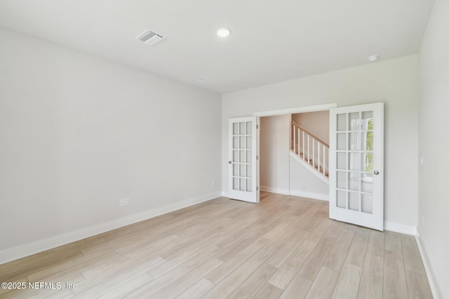 10266 Element Rd, Jacksonville, FL 32256 - empty room featuring light wood finished floors, french doors, baseboards, stairway, and a smoke detector