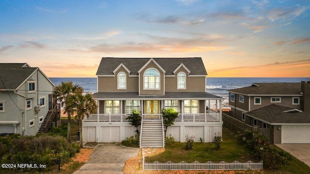 view of front of property with a water view and covered porch