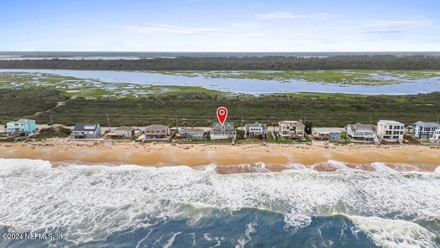 drone / aerial view featuring a water view and a beach view