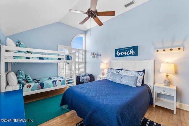 bedroom with ceiling fan, hardwood / wood-style floors, and lofted ceiling