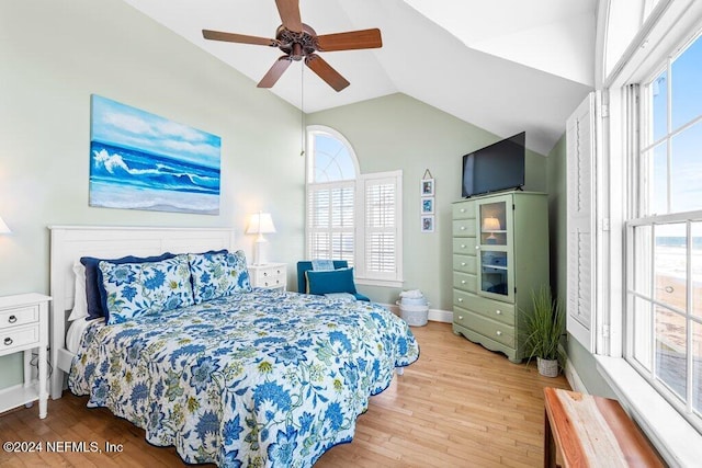 bedroom with ceiling fan, light hardwood / wood-style floors, lofted ceiling, and multiple windows