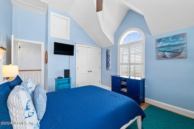 carpeted bedroom featuring ceiling fan and lofted ceiling