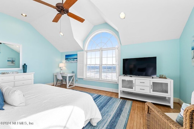 bedroom featuring multiple windows, ceiling fan, wood-type flooring, and lofted ceiling