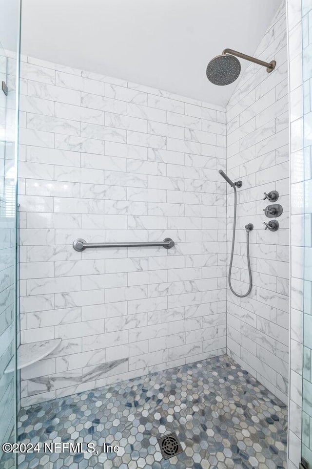 bathroom with tiled shower