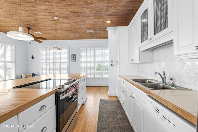 kitchen featuring stainless steel electric range oven, sink, pendant lighting, light hardwood / wood-style flooring, and white cabinetry