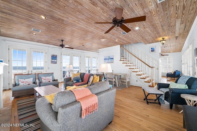 living room featuring light hardwood / wood-style floors, wooden ceiling, and a wealth of natural light