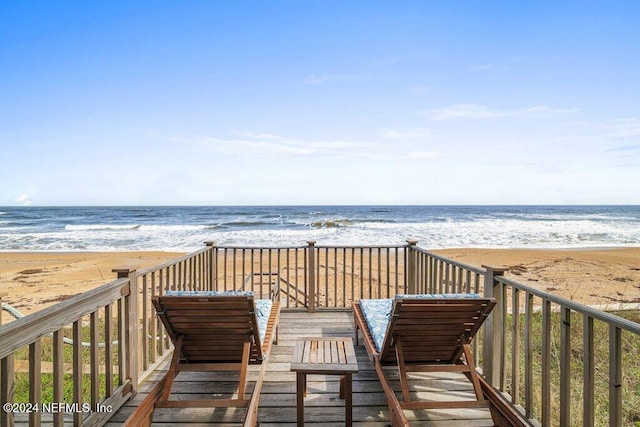 deck featuring a water view and a view of the beach