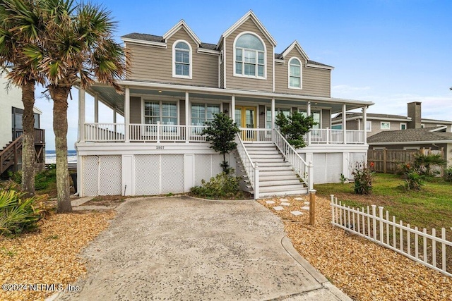 2807 S Ponte Vedra Blvd, Ponte Vedra Beach, FL 32082 - coastal inspired home with stairway, a porch, and fence