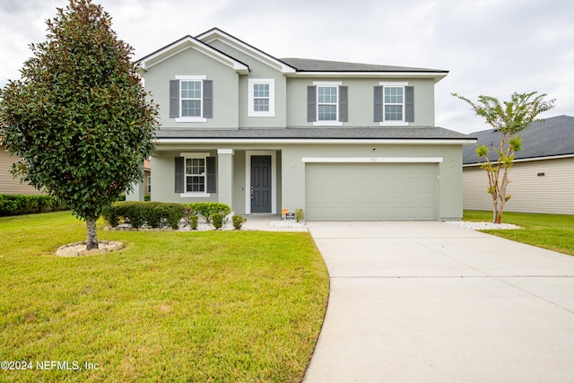 front facade with a garage and a front lawn