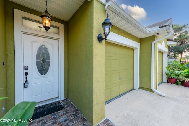 view of exterior entry with a garage