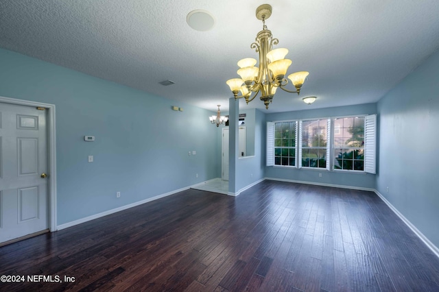 interior space with a textured ceiling, a chandelier, and dark hardwood / wood-style flooring