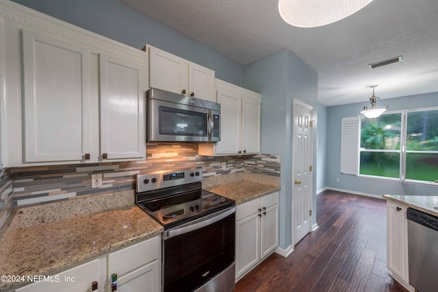 kitchen featuring white cabinets, stainless steel appliances, dark hardwood / wood-style flooring, and decorative light fixtures