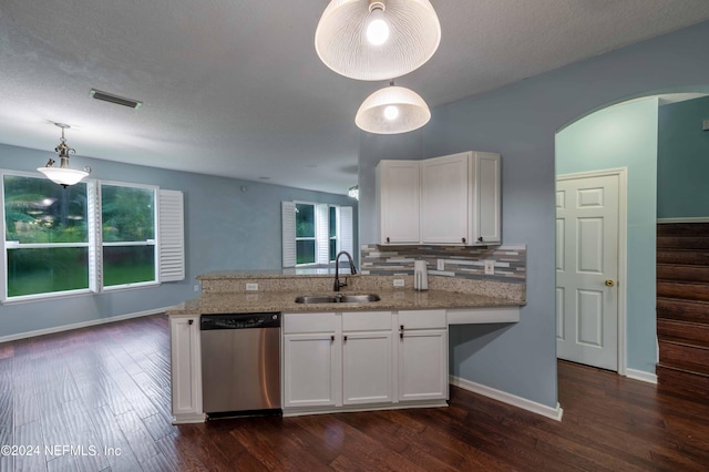 kitchen with hanging light fixtures, white cabinets, and dishwasher