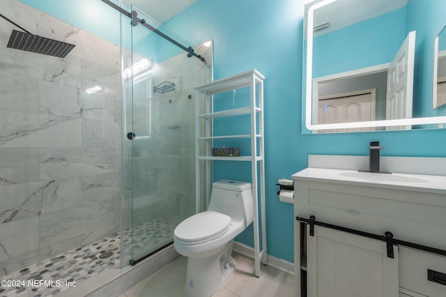 bathroom featuring tile patterned floors, toilet, a shower with door, and vanity